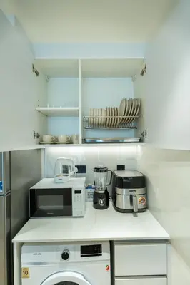 a kitchen with a microwave and a toaster at Chic Comfort - Stylish One-Bedroom in Dubai