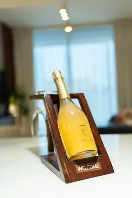 a bottle of wine sitting on top of a counter at Chic Comfort - Stylish One-Bedroom in Dubai