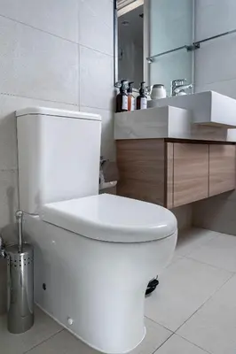 a bathroom with a white toilet and a sink at Nasma Luxury Stays - Trendy & Stylish Living Studio at Azizi Riviera 41 in Dubai