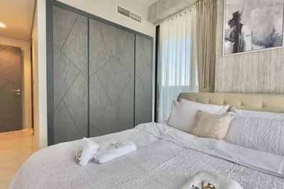 a bedroom with a large bed with towels on it at Relaxing 2BR Escape with Private Pool Samana GA by Vibel in Dubai