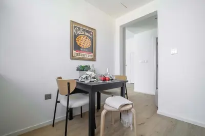 a dining room with a table and two chairs at Frank Porter - DEC Tower 3 in Dubai