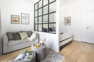 a living room with a couch and a table at Frank Porter - DEC Tower 3 in Dubai