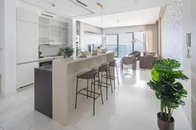 a kitchen with a island with bar stools at Frank Porter - The One JBR in Dubai