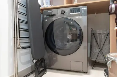 a washing machine in a room with a speaker at Downtown Views Open Burj View 34th Floor 2BD in Dubai