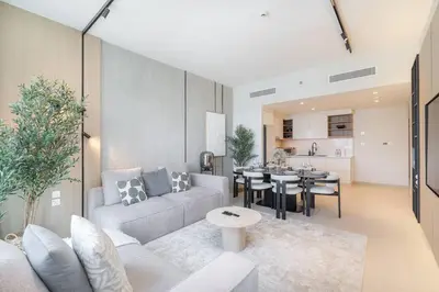 a living room with a couch and a table at Downtown Views Open Burj View 34th Floor 2BD in Dubai