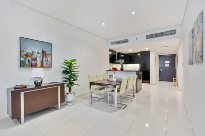 a kitchen and dining room with a table and chairs at 3BR Apartment in Business Bay with Pool & Canal Walk in Dubai