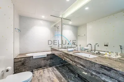 a bathroom with two sinks and a toilet at Luxurious 2BR at DAMAC Heights, Dubai Marina by Deluxe Holiday Homes in Dubai