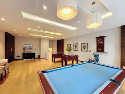 a living room with a pool table in it at Luxurious 2BR at DAMAC Heights, Dubai Marina by Deluxe Holiday Homes in Dubai