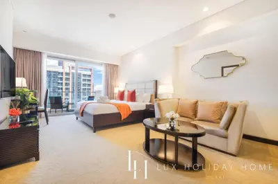 a hotel room with a bed and a couch and a table at LUX The JW Marina Studio 3 in Dubai