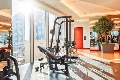 a gym with a cardio machine in a building at LUX The JW Marina Studio 3 in Dubai