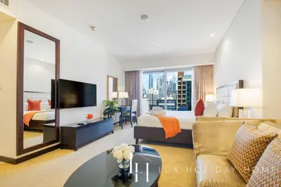 a hotel room with a bed and a large mirror at LUX The JW Marina Studio 3 in Dubai