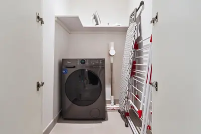 a washer and dryer in a laundry room at Pool side view at Dubai Creek Harbour by DuStay in Dubai