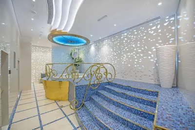 a staircase in a room with a blue and white wall at FIRST CLASS 1BR Amazing Marina Views in Dubai