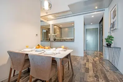 a dining room with a white table and chairs at FIRST CLASS 1BR Amazing Marina Views in Dubai