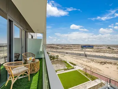 a balcony with a view of the beach at Dar Mama - Cozy modern apartment in Golf Vita, Dubai in Dubai