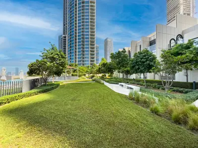 a park in the city with tall buildings at New! PS5! Burj Khalifa view & Infinity Pool in Dubai