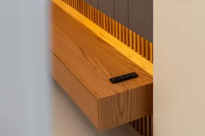 a wooden drawer with a black bottle in it at Spacious Apartment - Dubai Creek Harbour by DuStay in Dubai