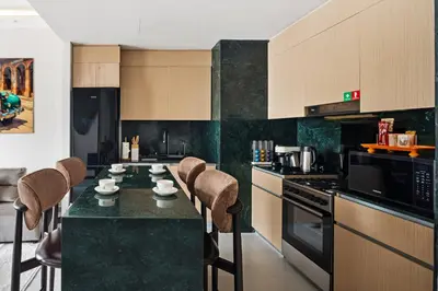 a kitchen with a counter with stools in it at Spacious Apartment - Dubai Creek Harbour by DuStay in Dubai