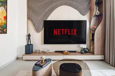 a living room with a netflix sign on a tv screen at Modern Apartment in Dubai Creek Harbour By DuStay in Dubai