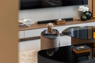 a living room with a table and a tv at Modern Apartment in Dubai Creek Harbour By DuStay in Dubai