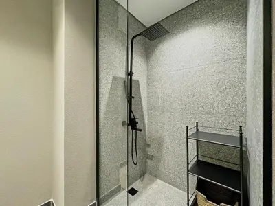a shower with a glass door in a bathroom at Chic and Bright Studio in Meydan in Dubai