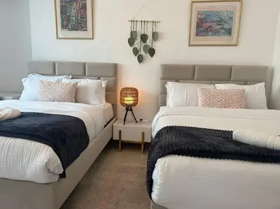 two beds sitting next to each other in a bedroom at 2 Bedrooms Apartment with Marina Views in Dubai