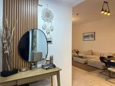 a living room with a mirror on a table at 2 Bedrooms Apartment with Marina Views in Dubai