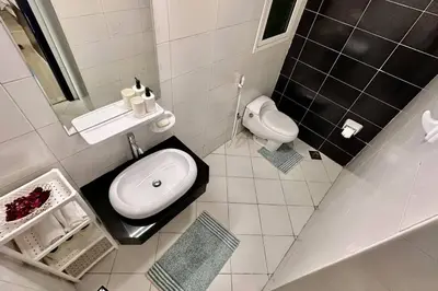 a small bathroom with a sink and a toilet at Himalaya Holiday Homes 1 BHK Apartment in Dubai