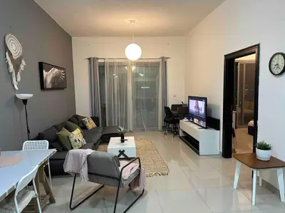 a living room with a couch and a tv at Himalaya Holiday Homes 1BHK - Dubai Marina in Dubai