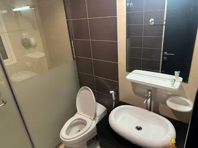 a small bathroom with a toilet and a sink at Himalaya Holiday Homes 1BHK - Dubai Marina in Dubai