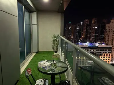 a balcony with a table and chairs and a city skyline at Himalaya Holiday Homes 1BHK - Dubai Marina in Dubai