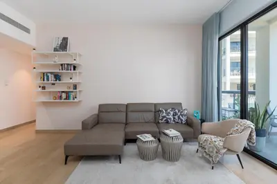 a living room with a couch and chairs at La Cote, Port de La Mer, Jumeirah 1 - Mint Stay in Dubai