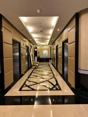 a hallway with a hotel lobby with ailed floor at Royal Apartments Dubai Mall in Dubai