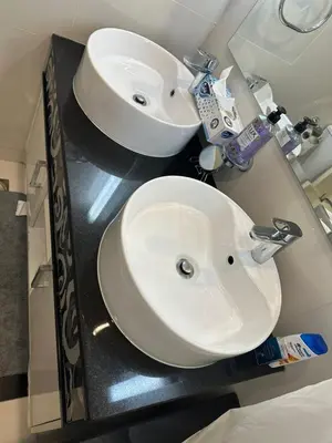 a bathroom with a white sink and a mirror at Royal Apartments Dubai Mall in Dubai