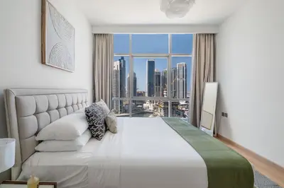 a bedroom with a large bed and a large window at GuestReady - Splendid Stay in Dubai Marina in Dubai