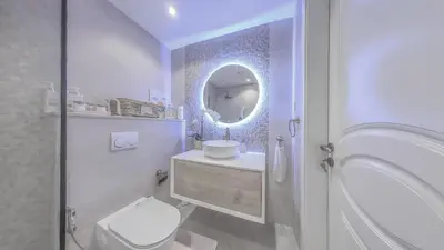 a bathroom with a toilet and a sink and a mirror at Elegant 2 Bedroom Apartment in Dubai Marina- Just 1 Min walk from JBR Beach in Dubai
