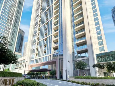 a tall building in a city with tall buildings at Minimal 1BR Minutes away from the Dubai Mall in Dubai