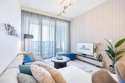a living room with a couch and a tv at Minimal 1BR Minutes away from the Dubai Mall in Dubai
