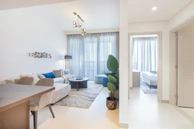 a living room with a couch and a table at Minimal 1BR Minutes away from the Dubai Mall in Dubai