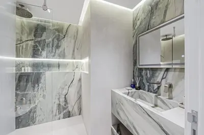 a bathroom with a sink and a mirror at Luxury at Beachside Al Sultana Jumeirah Shoreline - DVH Holiday Homes in Dubai
