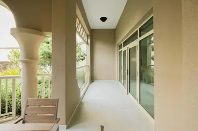 a hallway of a house with a bench on a balcony at Luxury at Beachside Al Sultana Jumeirah Shoreline - DVH Holiday Homes in Dubai