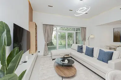 a living room with a white couch and a table at Luxury at Beachside Al Sultana Jumeirah Shoreline - DVH Holiday Homes in Dubai