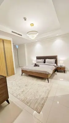 a large bedroom with a bed and a rug at Luxury 2BR Midtown Apartment in Dubai