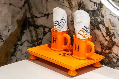 two orange coffee mugs with socks on a yellow tray at Breathtaking Dubai Skyline view apartment - By DuStay in Dubai