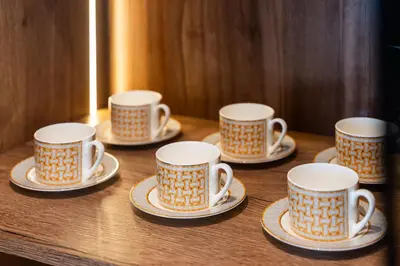a group of cups and saucers on a table at Luxury Apartment at Dubai Creek Harbour, Bayshore - By DuStay in Dubai