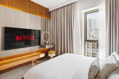 a hotel room with a bed and a television at Stylish Poolside Apartment in Dubai Creek Harbour - By DuStay in Dubai