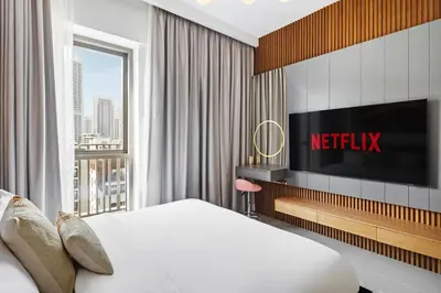 a hotel room with a bed and a television at Luxury Getaway Apartment at Dubai Creek Harbour - By Dustay in Dubai