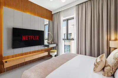 a hotel room with a bed and a television at Luxury, Spacious Apartment in Dubai Creek Harbour - By DuStay in Dubai