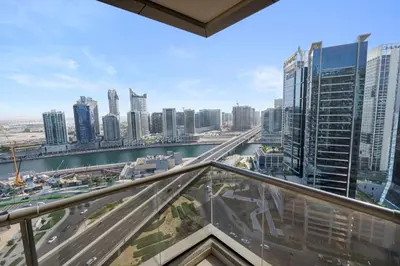 a view of a city with tall buildings at Cozy 2BR in Elite Downtown Residence with Canal view in Dubai