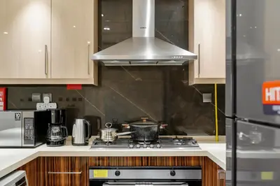 a kitchen with a stove with a pot on it at Cozy 2BR in Elite Downtown Residence with Canal view in Dubai